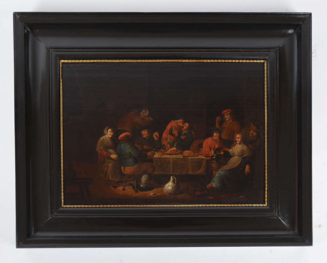 A framed oil painting on an oak panel of a tavern scene, signature in the bottom left 'P. Quast,f.