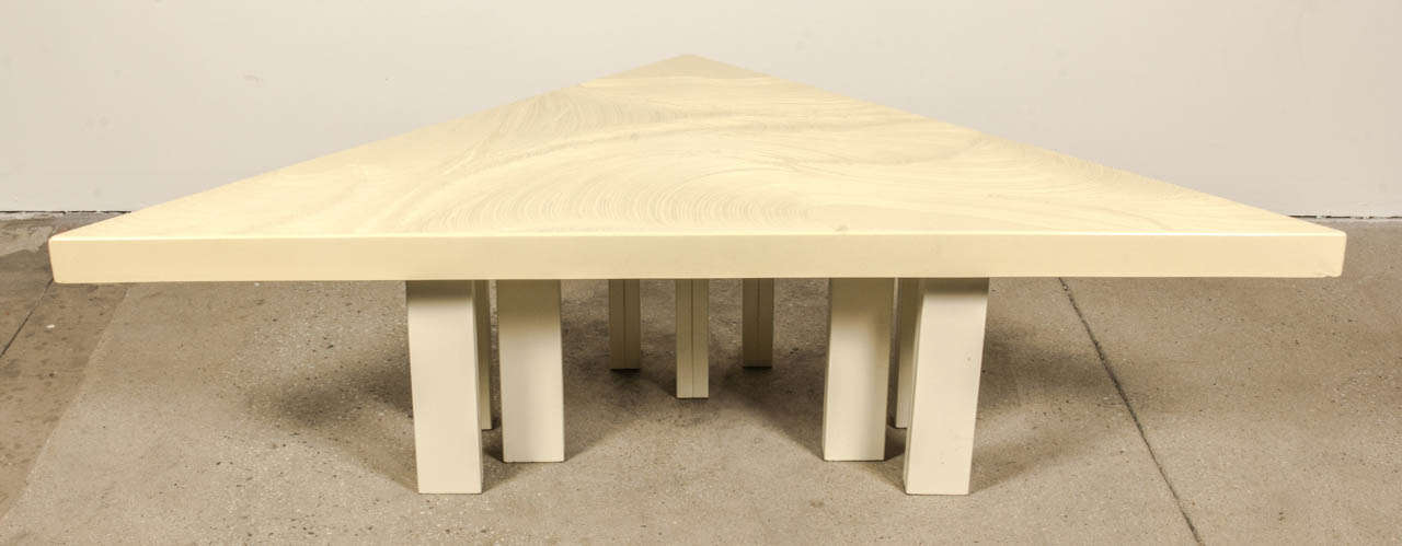 A wonderful and rare triangular coffee table by Fernand Dresse in cream resin.