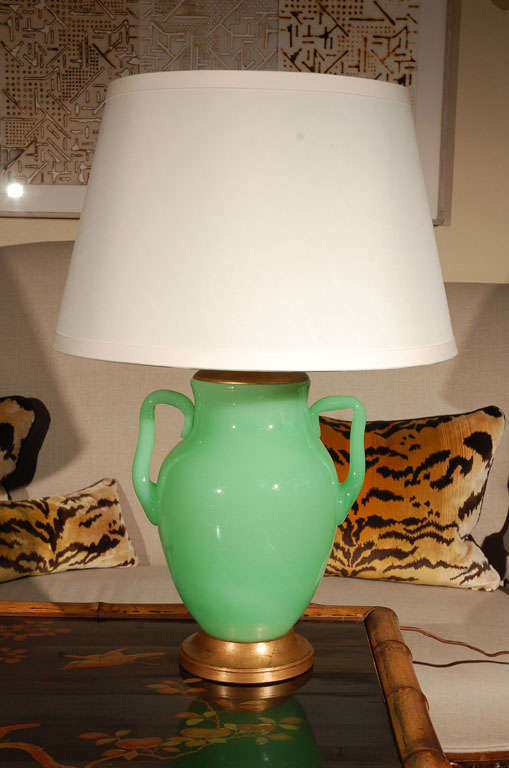 Bright green, urn-shaped Opaline lamp with gold foot.