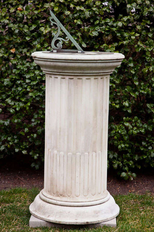 A fluted columnar carved marble pedestal with bronze sundial. Provenance: Seago, Pimlico, London