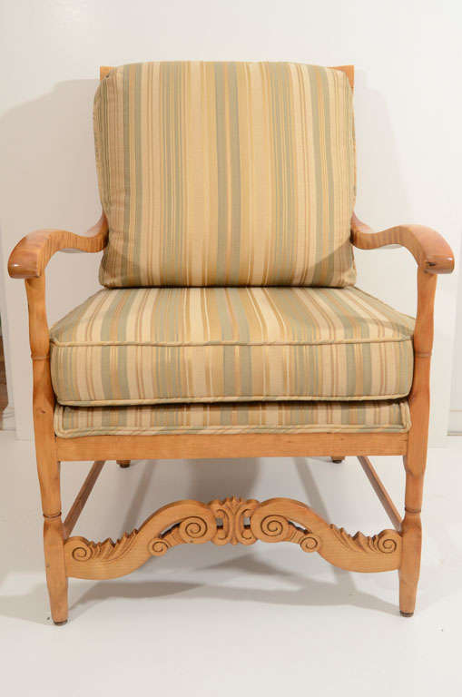Gustavian inspired armchair, with exuberantly carved front stretcher, reflected in the curved seat rails and back slats. Recently upholstered , with a padded seat and loose seat and back cushions.