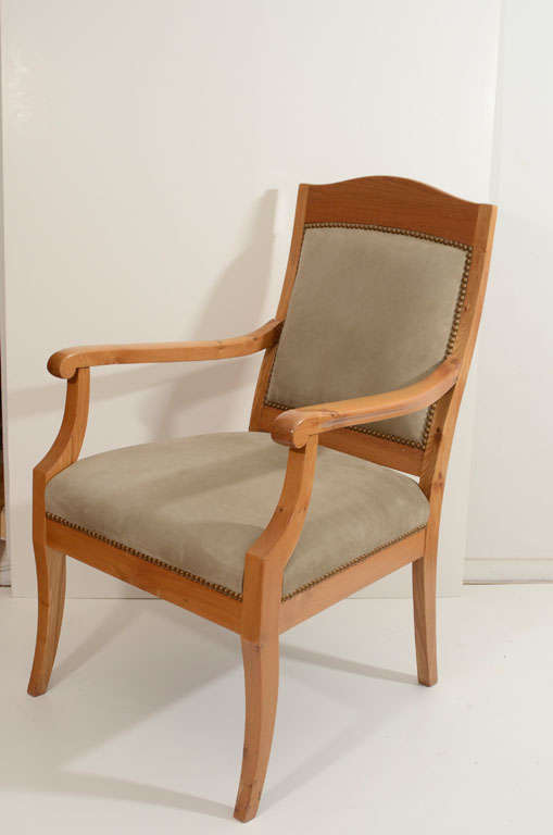 The high upholstered back combined with wide and deep seat exemplify the Classic and comfortable Scandinavian Art Nouveau design. Sophisticated while still cozy and solid, this smooth chair sacrifices nothing! The subdued, neutral tones of the wood