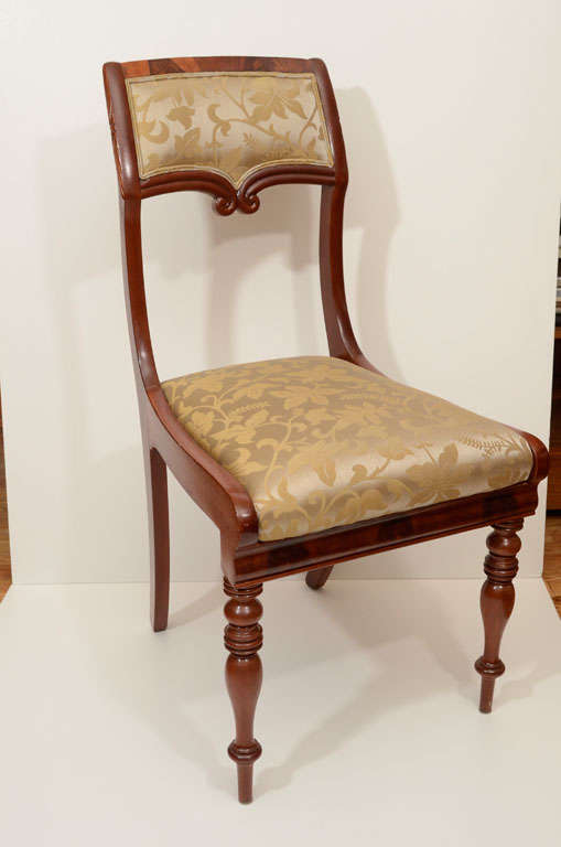 Biedermeier dining chairs in mahogany with turned and fluted legs. Set-in seat is fully cushioned and recently reupholstered in a damask fabric.