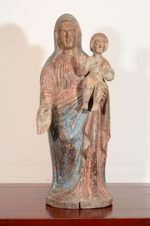 Carved wooden statue of Mary holding baby Jesus. Painted robes and faces. From South Indian province of Kerala.

JC-5 