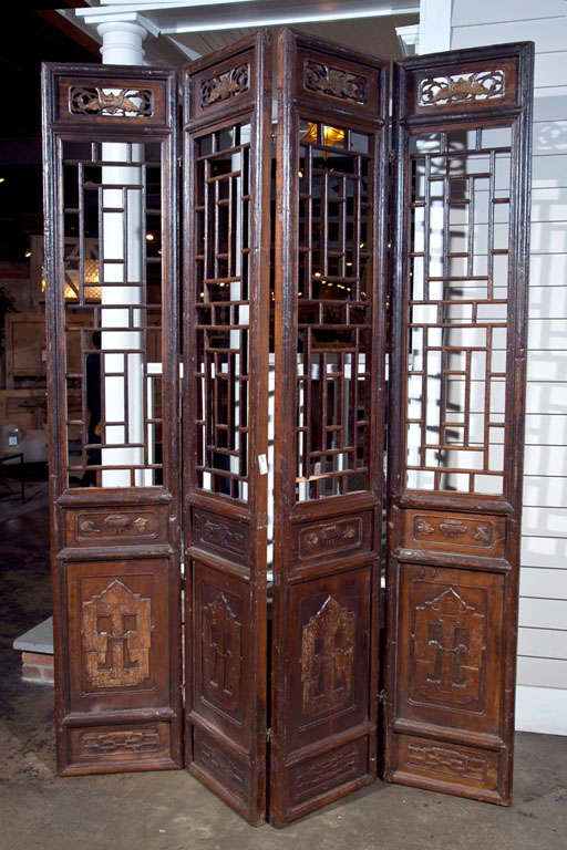 Chinese carved elm screen composed of four doors from the late 19th century and retaining its old lacquer finish.