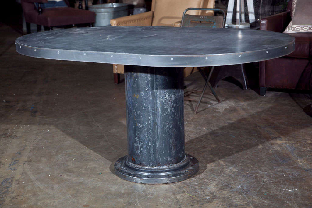 Industrial Base Oval Dining Table with a circular column iron base, c. 1950, now with an oval steel top