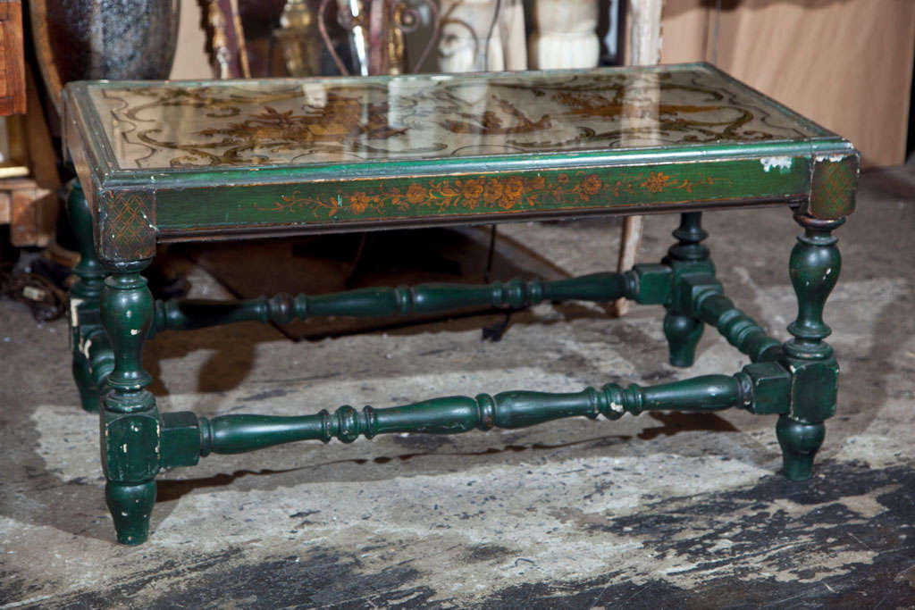Vintage coffee table with an eglomise decorated mirror top, c. 1940 with painted/decorated turned leg base with stretchers