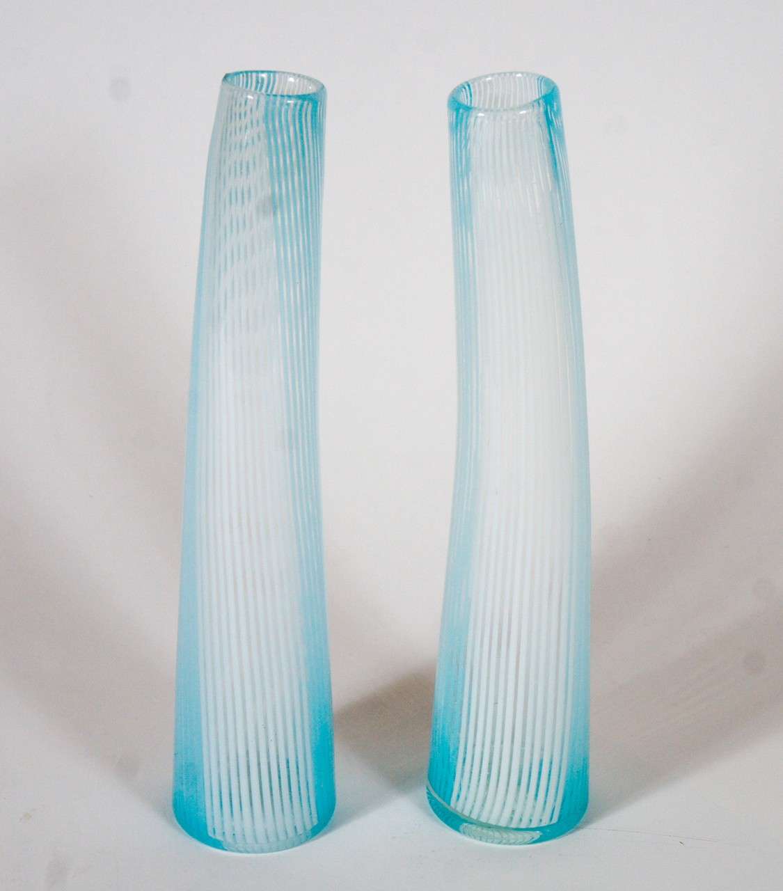 Lean and elegant, these Murano vases have bowed shapes and pulled linear decoration. Hand blown in Italy.