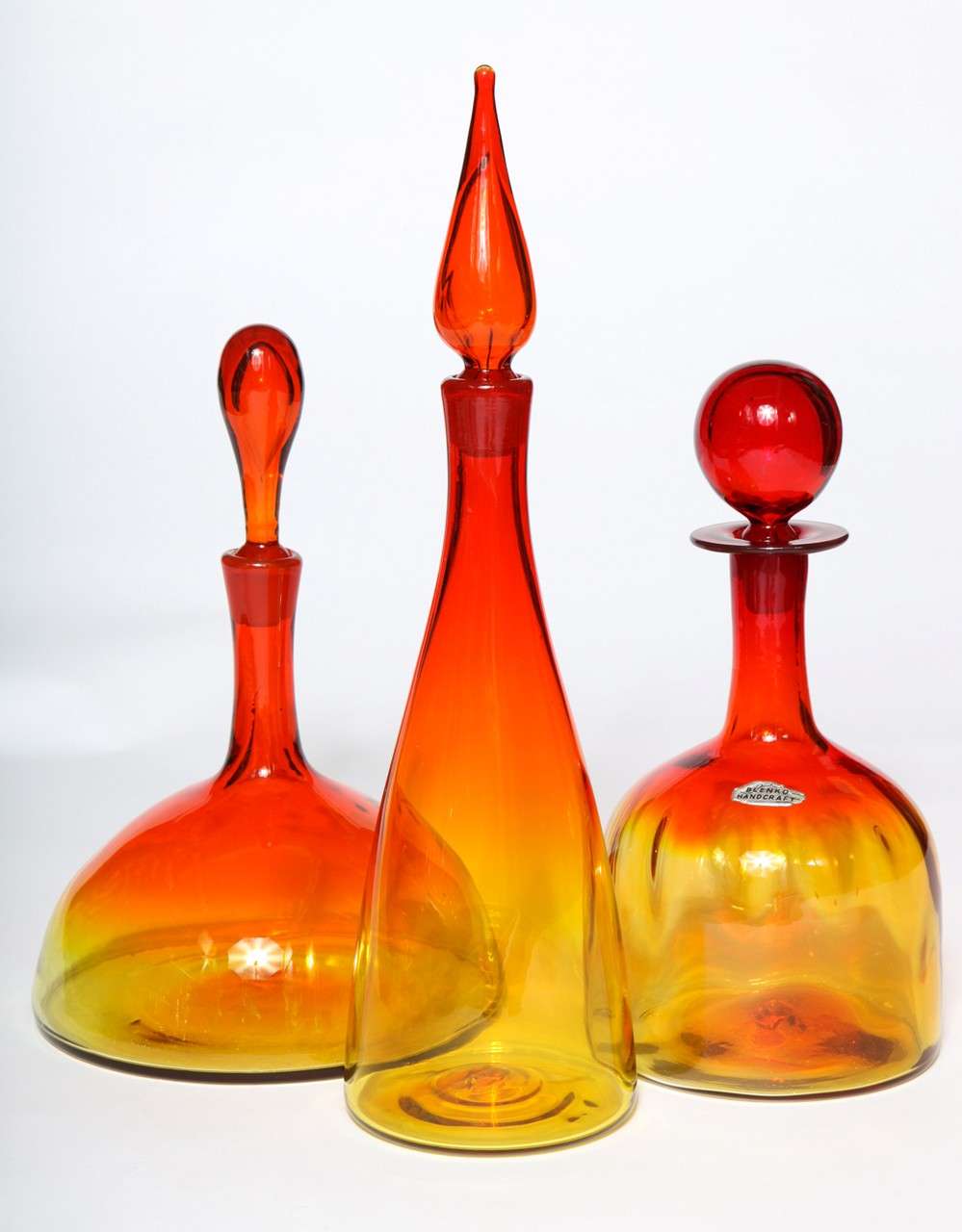 A dramatic and colorful trio of Blenko glass decanters. Striking tangerine color. Can be purchased individually.

Left to Right:
13