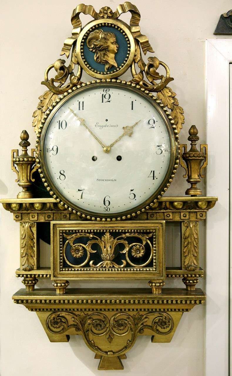 A Swedish Gustavian Signed Wall Clock. Signed By Engstrom. Robert Engström was born in 1864 and died in 1926. A well-known clockmaker in Stockholm, he specialized in gilt wood wall clocks in both Gustavian and empire styles. He received the royal