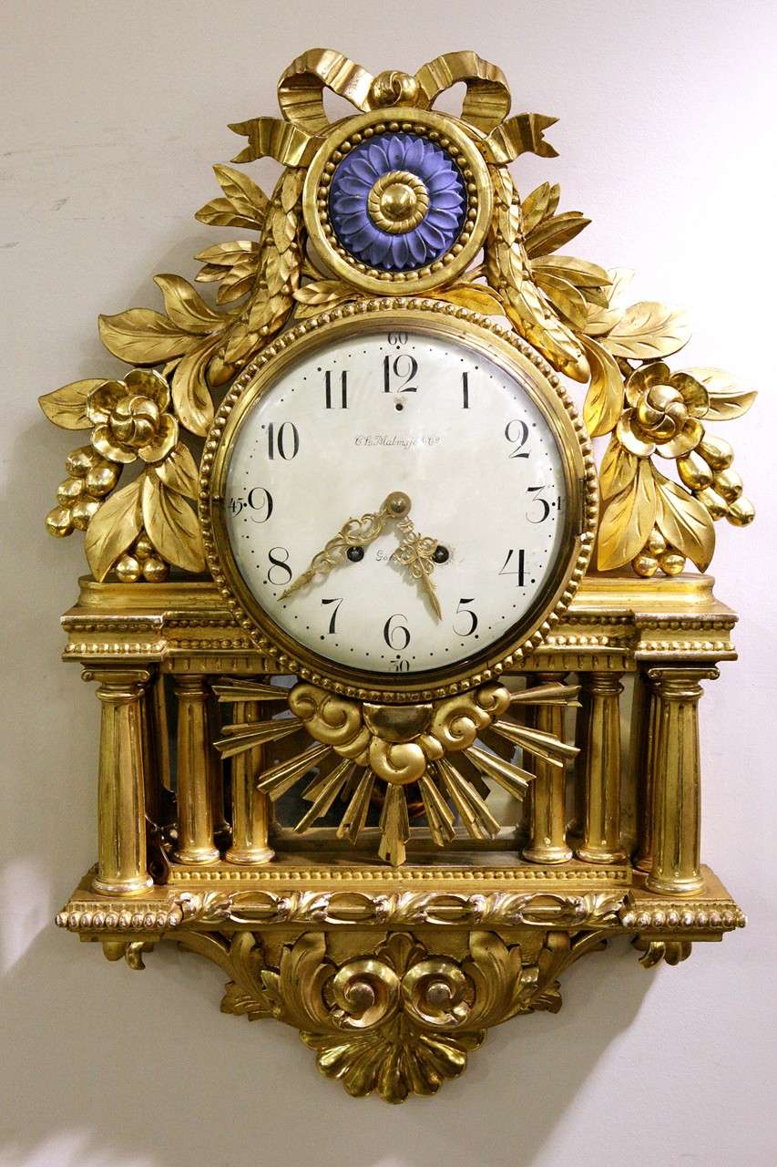 A Continental gilt wood cartelle clock, C. L. Malmsjo & Co., Goteborg, late 19th century, 8-day bell striking movement by Lenzkirch, painted enamel dial, Arabic numerals, within an ornate pierced and carved case with laurel leaf decoration and a
