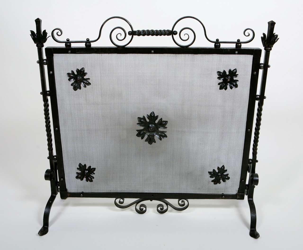 A good fire screen having decorative scrolls and twisted elements. The screen is English, circa the 1920 -30's and will look good in a fireplace and other locations. Jefferson West antiques offer a selection of antique decorative accessories,