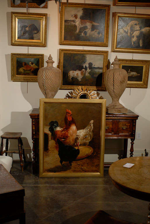 A Henry Schouten 19th century rooster and hens painting, signed lower left. This large size vertical format 19th century Schouten painting depicts a rooster and two hens eating from a plate casually placed on the ground. The vivid realism of the