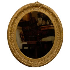 Antique English 1870s Oval Giltwood Carved Mirror with Floral Arabesques and Small Crest