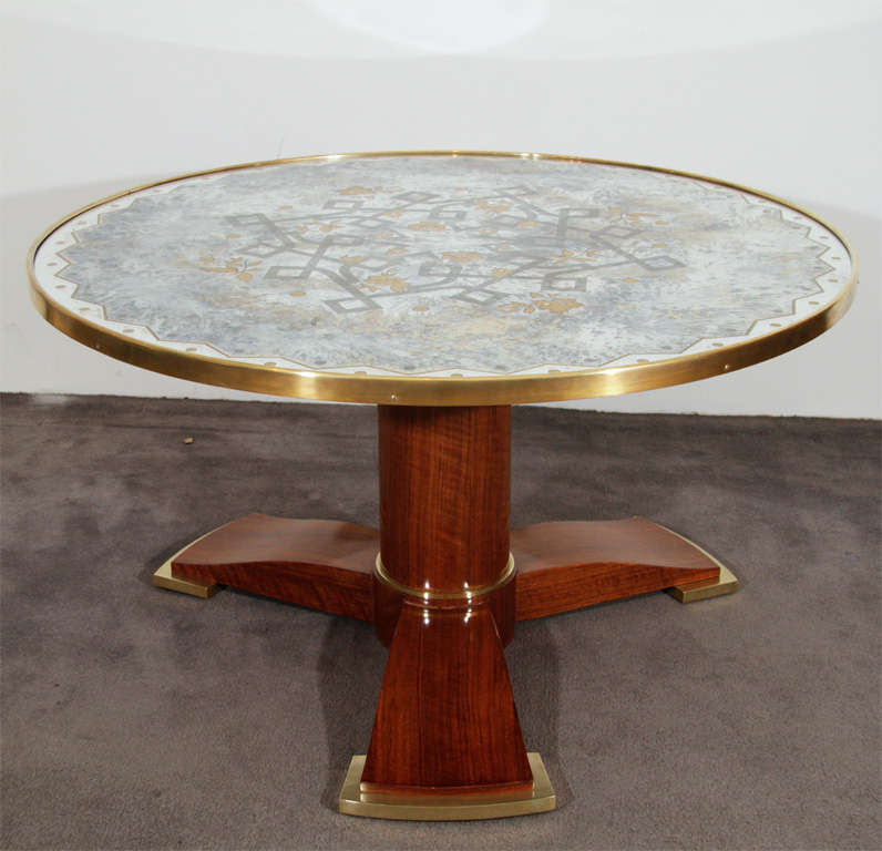 Fine coffee table by Leleu raised on walnut tripod pedestal base with gilt-bronze feet and fine original églomisé (glass painted from behind) mirrored top.<br />
Numbered: 23006<br />
Signed on ivory plaque: JLeleu<br />
<br />
Bibliography: 