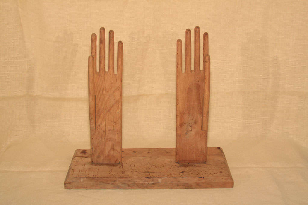 wood glove stretchers mounted to wooden board, French