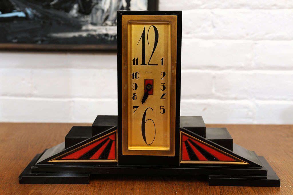 Enameled brass and marble table clock typical of the 20's period.