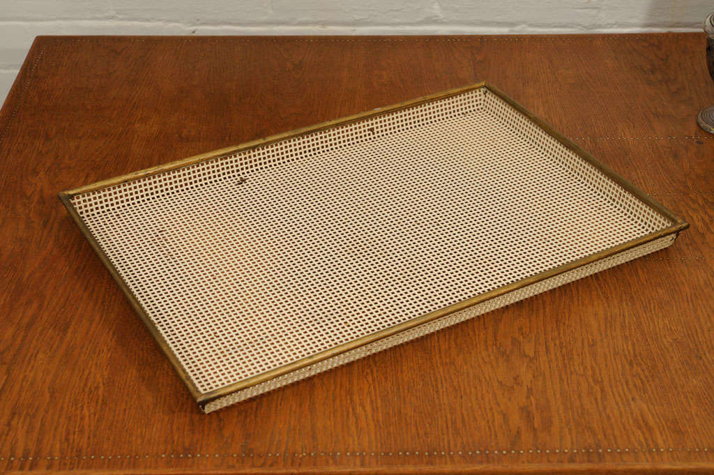 Pierced metal tray painted off white with gold border.
Unsigned.