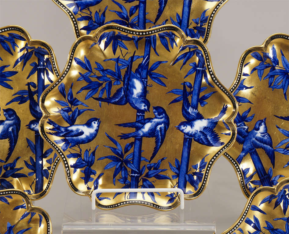This is an exceptional and beautifully decorated dessert service. Each plate has an unusually shaped rim with cobalt blue, gold and white raised enamel 