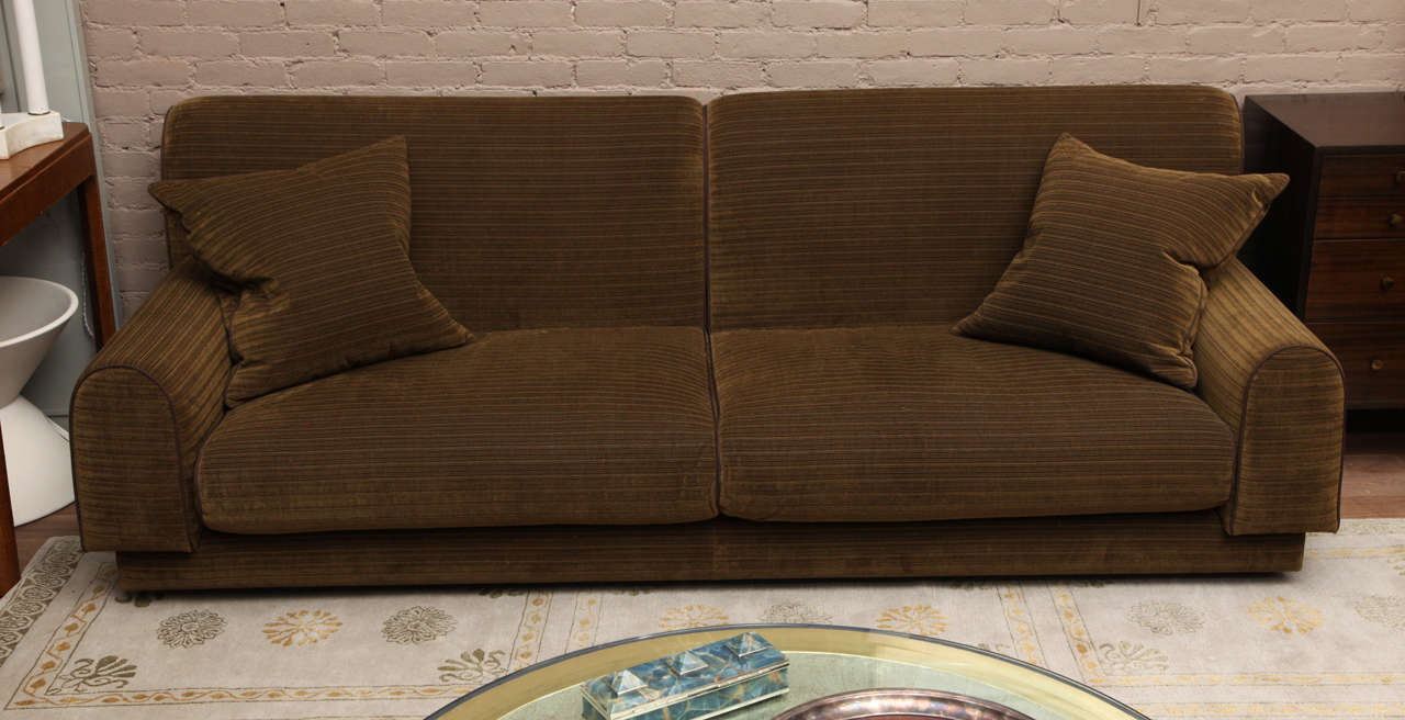 Low, lounging sofa, circa 1960 reupholstered in antique brass horizontal stripe velvet for Lee Jofa.