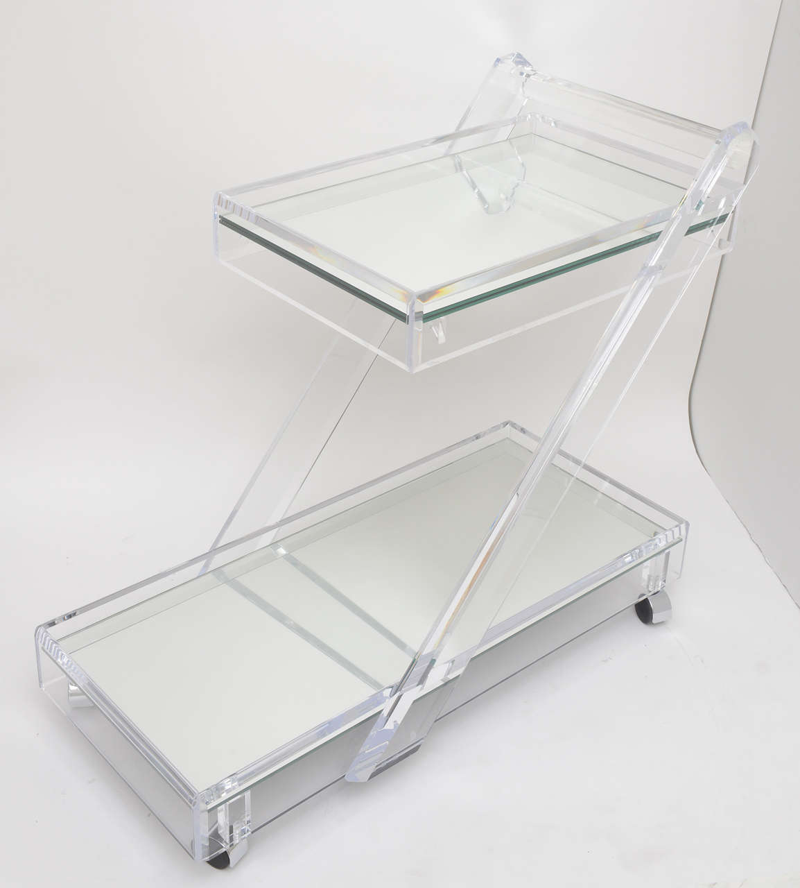 1970's two tier Lucite and mirror bar cart.

Please feel free to contact us directly for a shipping quote or any additional information by clicking 