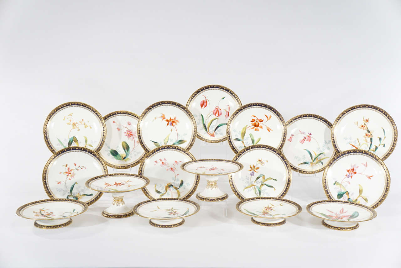This is a complete 19th century dessert service made by the small and highly respected firm of William Brownfield. Each plate is hand-painted with an orchid specimen, delicately depicted in naturalistic form. The polychrome enamels are framed by a