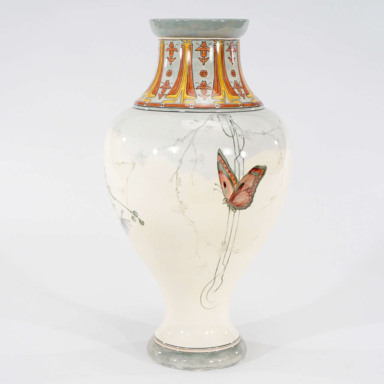 This is an extraordinary French monumental porcelain vase which is the embodiment of Art Nouveau decoration. Hand-painted polychrome enamels depicting a semi-nude female figure in a flowing transparent gown, encircles the vase with the reverse