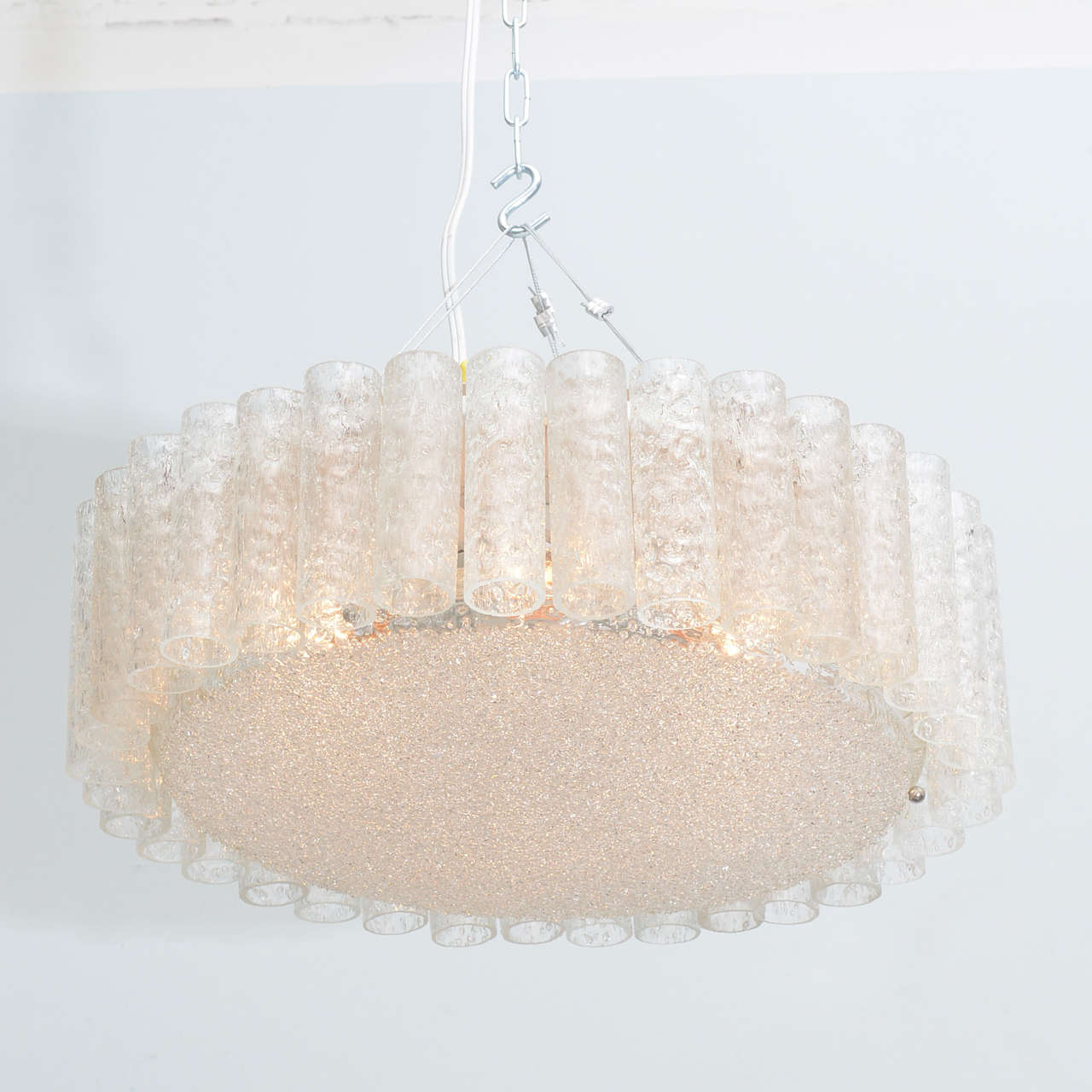 Handblown glass tubes encircling a central disc, can be flush mount or suspended.