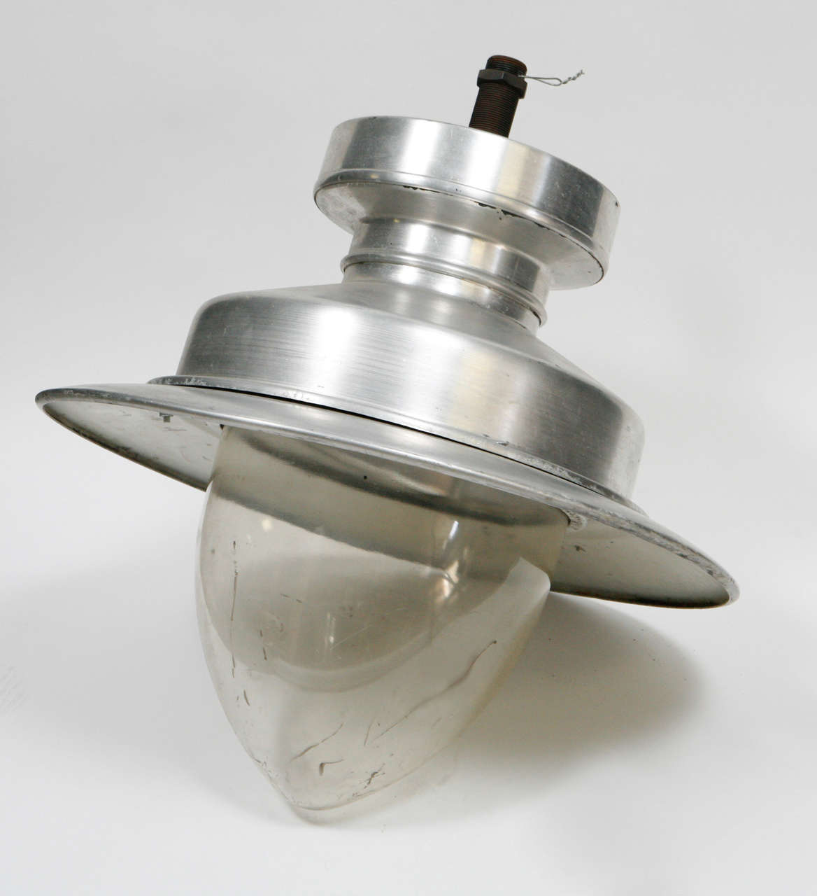 Early 20th-century industrial ceiling lamp from England. With a dish-shaped chrome hood and almond-shaped bulb, the piece has a great finish and hip, urban feeling. Would need rewiring in order to be made functional.

England, circa