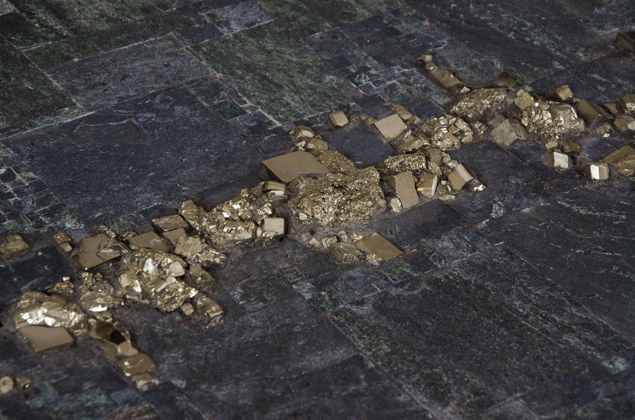 Pyrite and Brasilian Shiste stone tabletop on metal base,
set with signature plaque 'PIA MANU'.