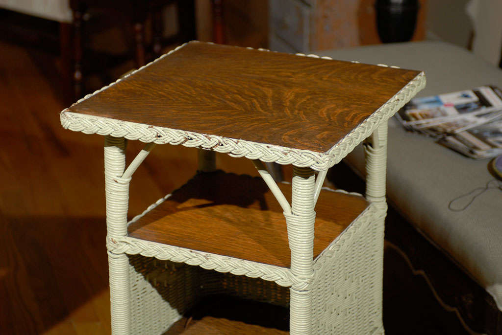 This is  an American wicker telephone table in the Art Deco style.  The braiding is repeated on all three shelves.  The woven diamonds are on both sides.  This table can be used in many areas of a house or porch.  American wicker is a wonderful