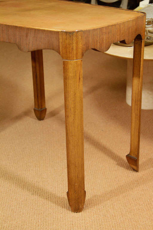 Pair of Unique Side tables have a wonderful apricot cream leather top. The legs taper into arrow shapes. Tops are slightly pie shaped.