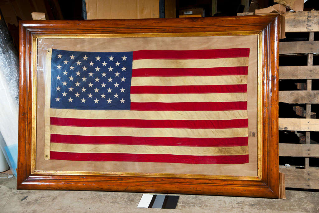 vintage american flag in wood and gold leaf frame
