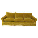 A green velvet sofa designed by MICHAEL TAYLOR