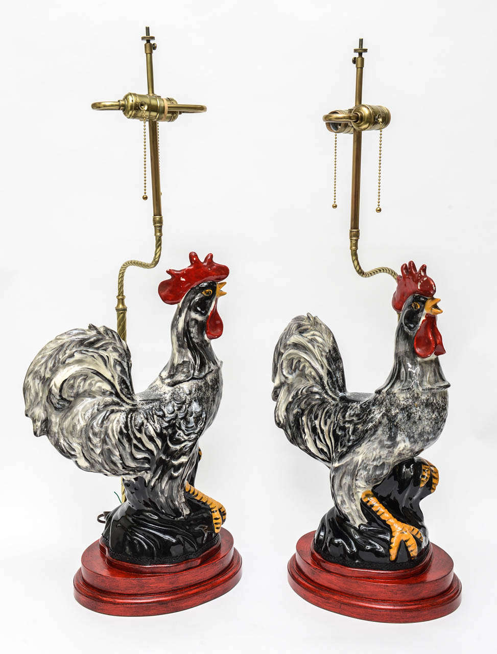 Fabulous pair of large scale Majolica rooster lamps on antiqued red bases.