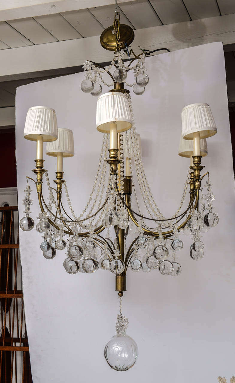 Unusual and beautiful modern brass and crystal chandelier with six arms.