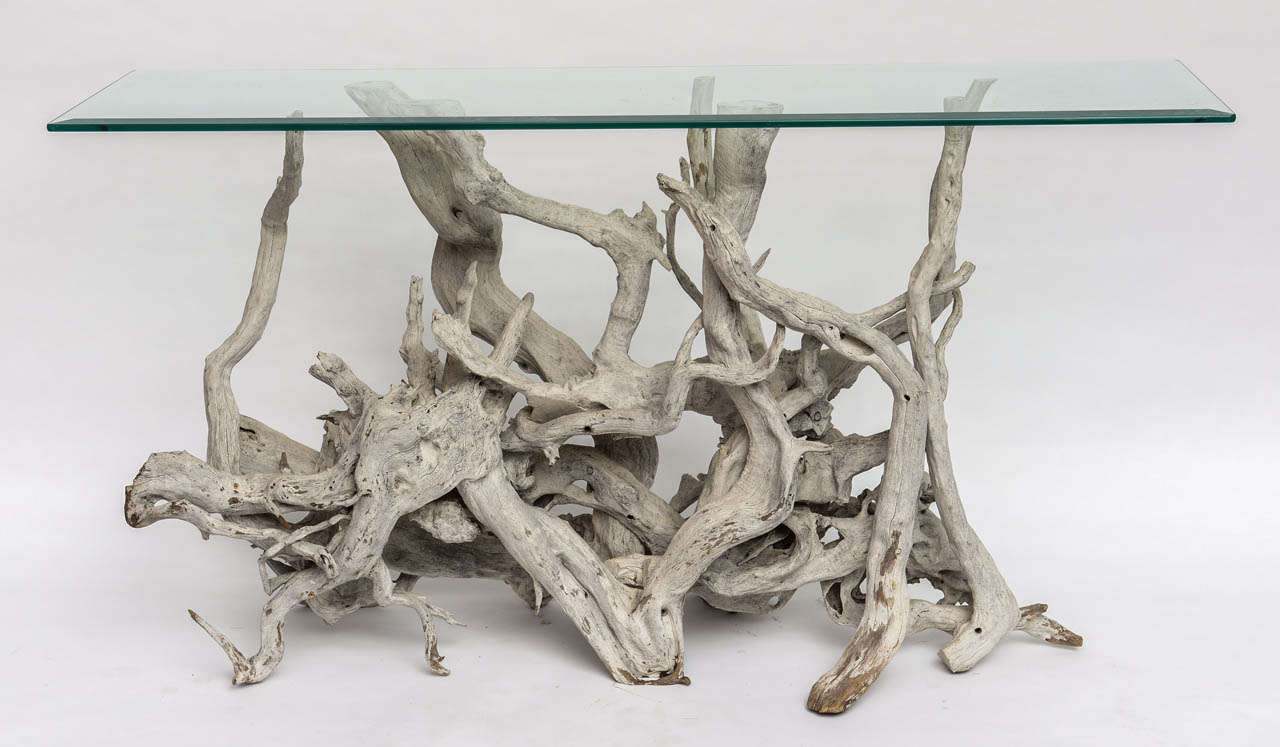 Elegant sun bleached driftwood console with glass top.