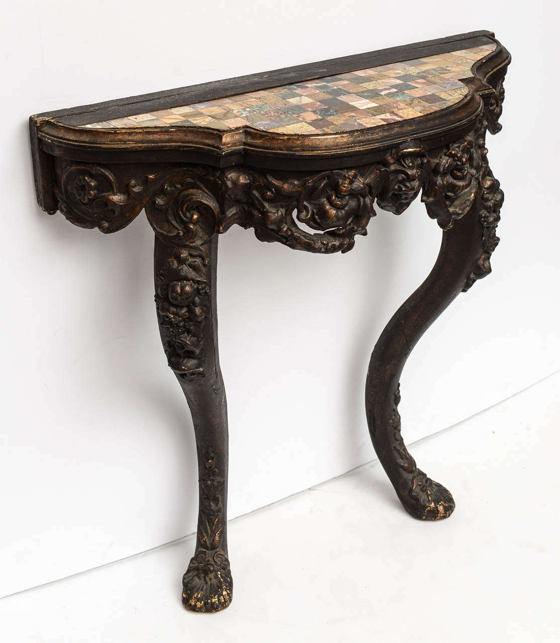 Beautiful Italian specimen marble demi-lune console with carved wood detail.