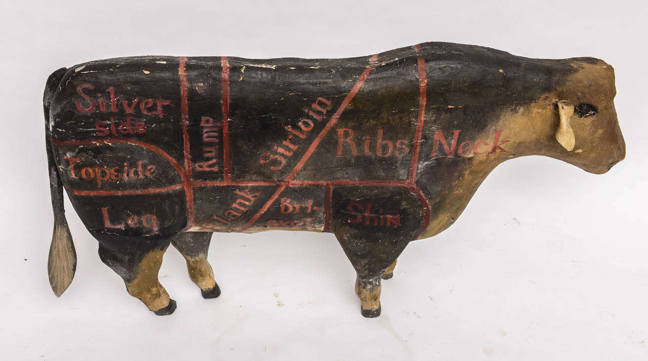 Wonderful old painted wood cow from a butcher's shop showing various cuts of beef. Leather ear.