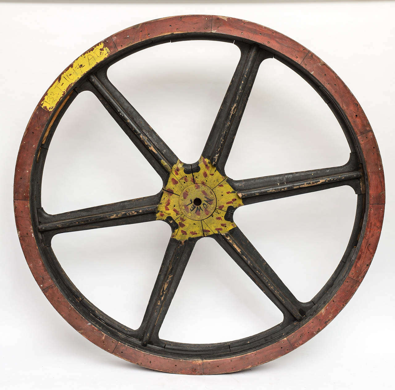 Fantastic painted wooden wheel from old industrial warehouse. Great wall art or table top!