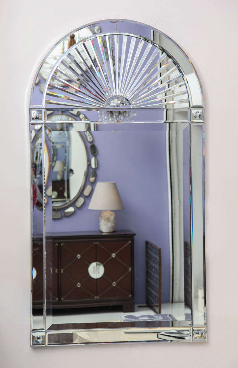 KARL SPRINGER (1930-1991)
Large Venetian style wall mirror with beveled edges 
and arched starburst at top. 
American, c. 1980