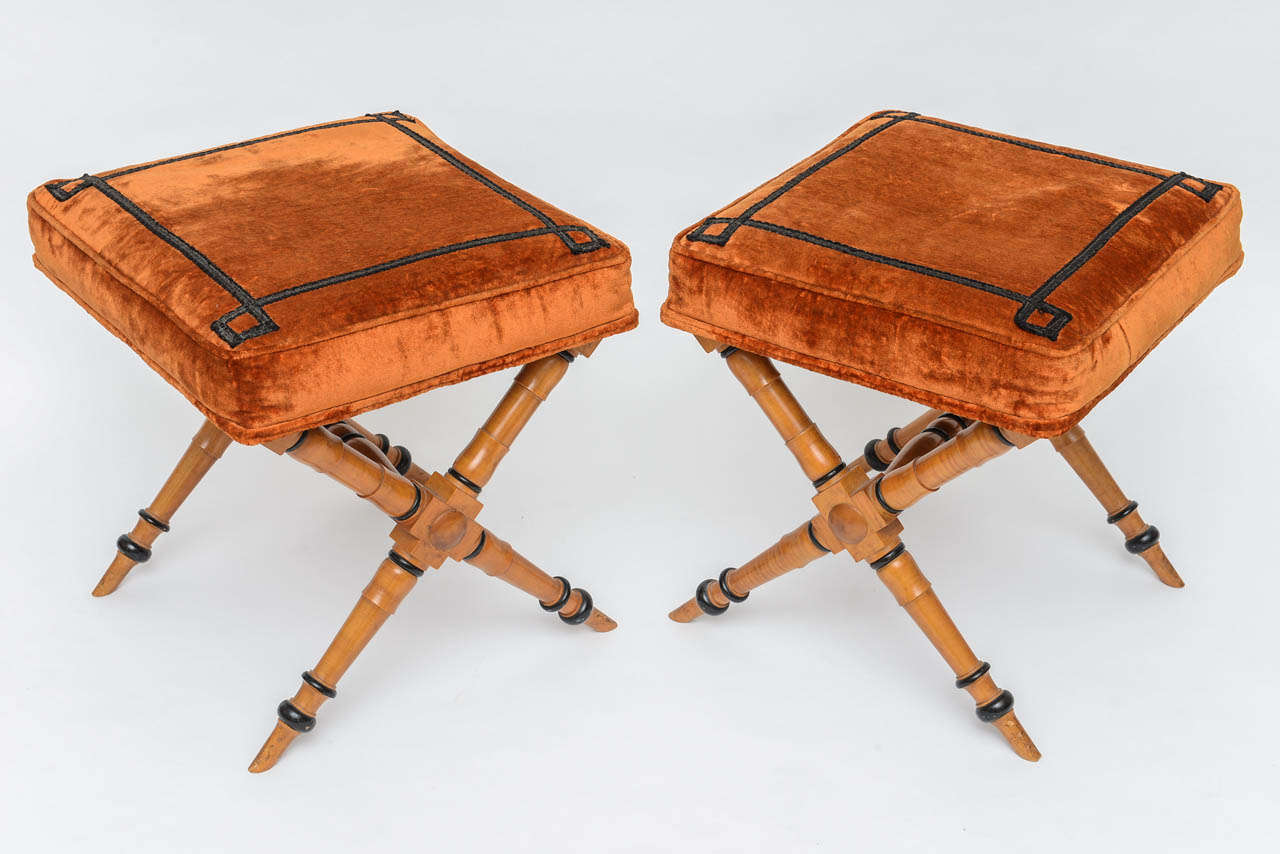 Pair of custom wooden 'X' benches in the Biedermeier style with sienna velvet cushions.