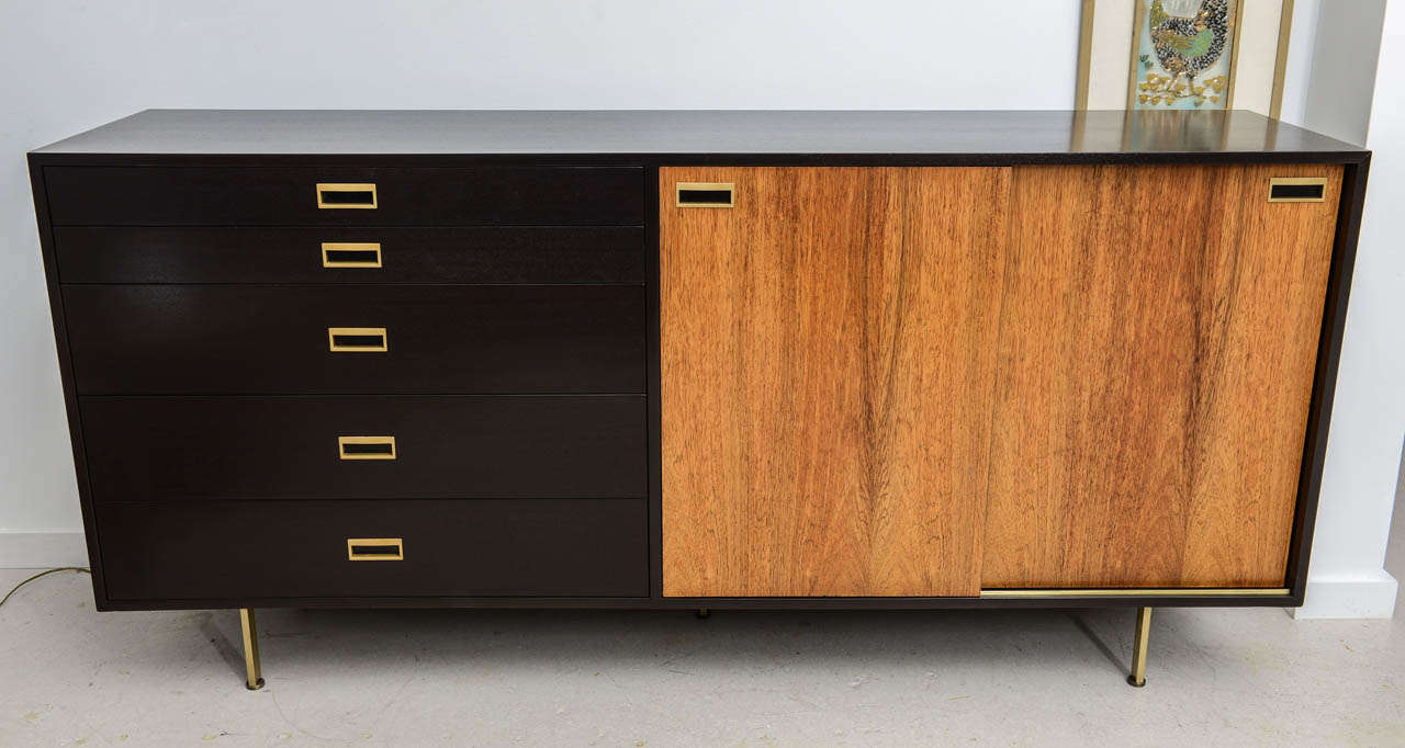 Harvey Probber sideboard/credenza five drawer & two sliding door credenza/dresser in walnut and ebonized mahogany with brass pulls, hardware, legs and runners.

 Harvey Probber metal tag attached inside the top drawer.