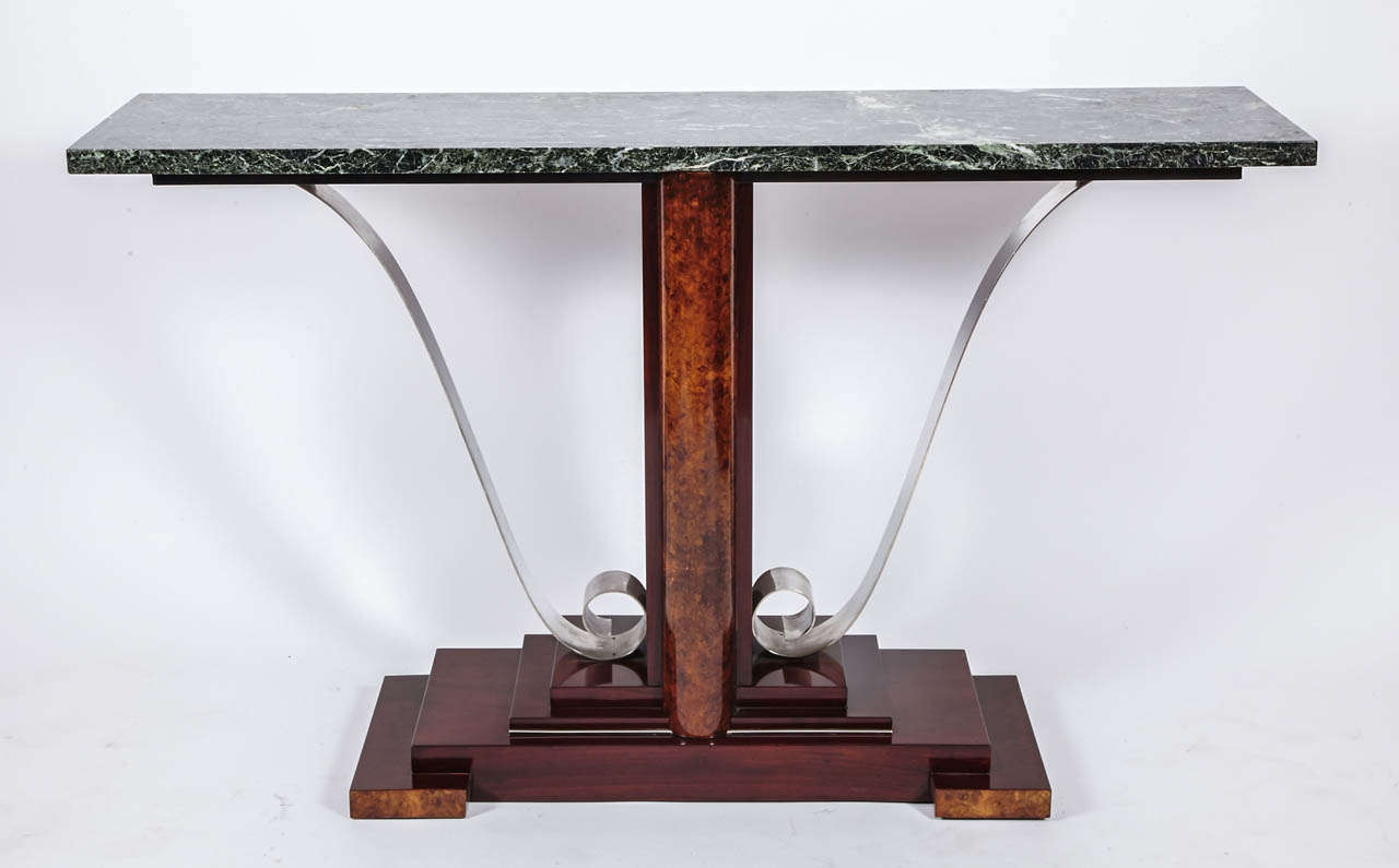 This elegant console table is in bird-eye's amboine, rosewood and bronze silver plated. The top is in green marble.
This console stand alone.
Create by stairs like a building; this model is typical from the Art Deco period.