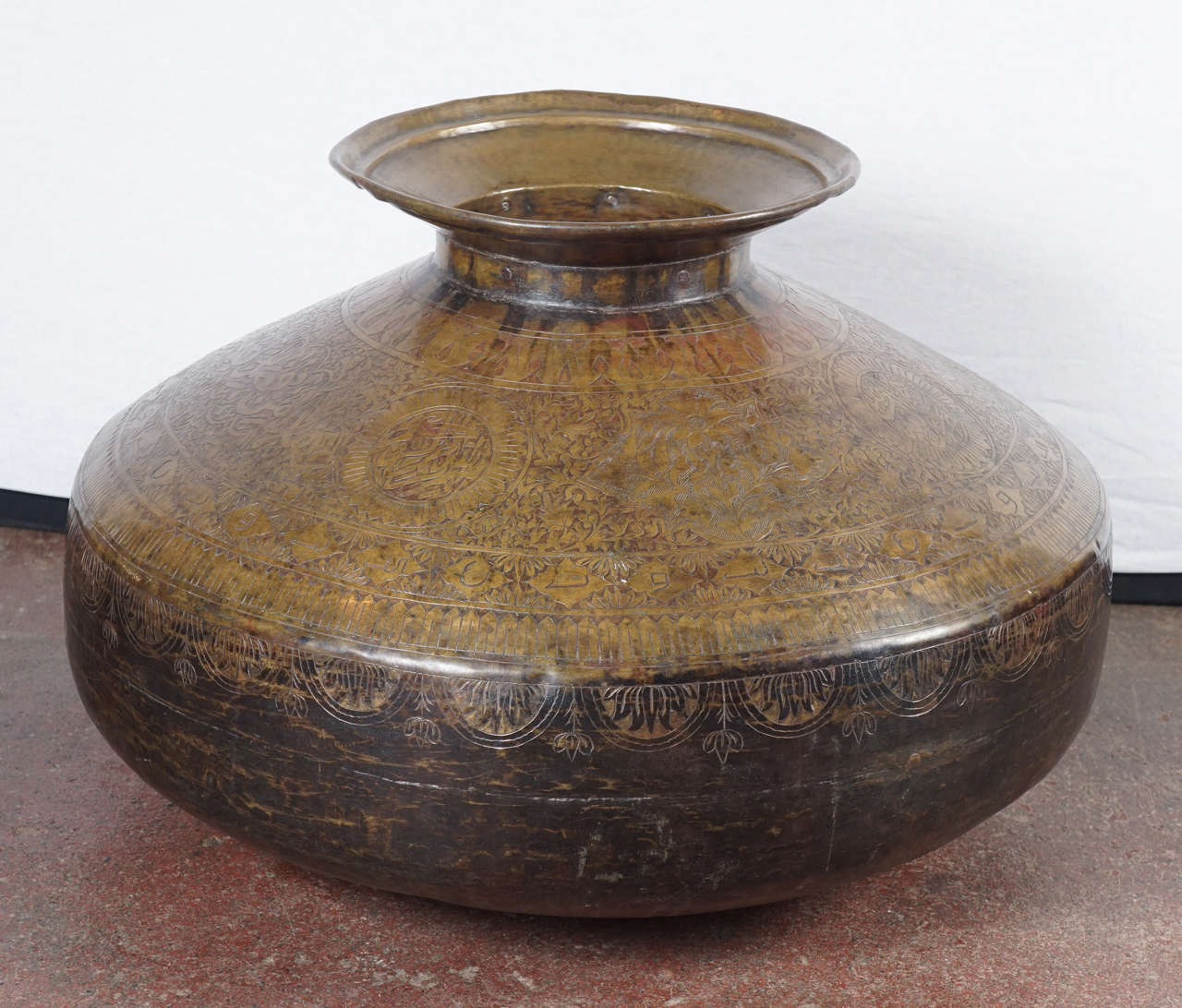 Delicate Sanskrit etching adorns this curvaceously hand-forged pot from Northern India.