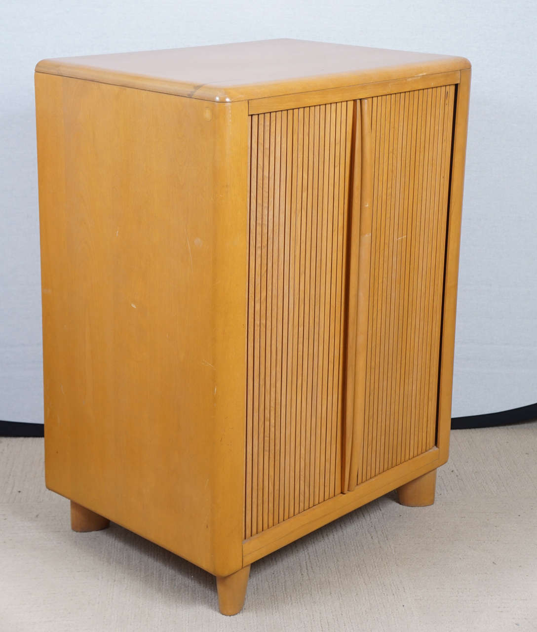 A rare Heywood-Wakefield wheat tambour door cabinet, stamped on reverse 