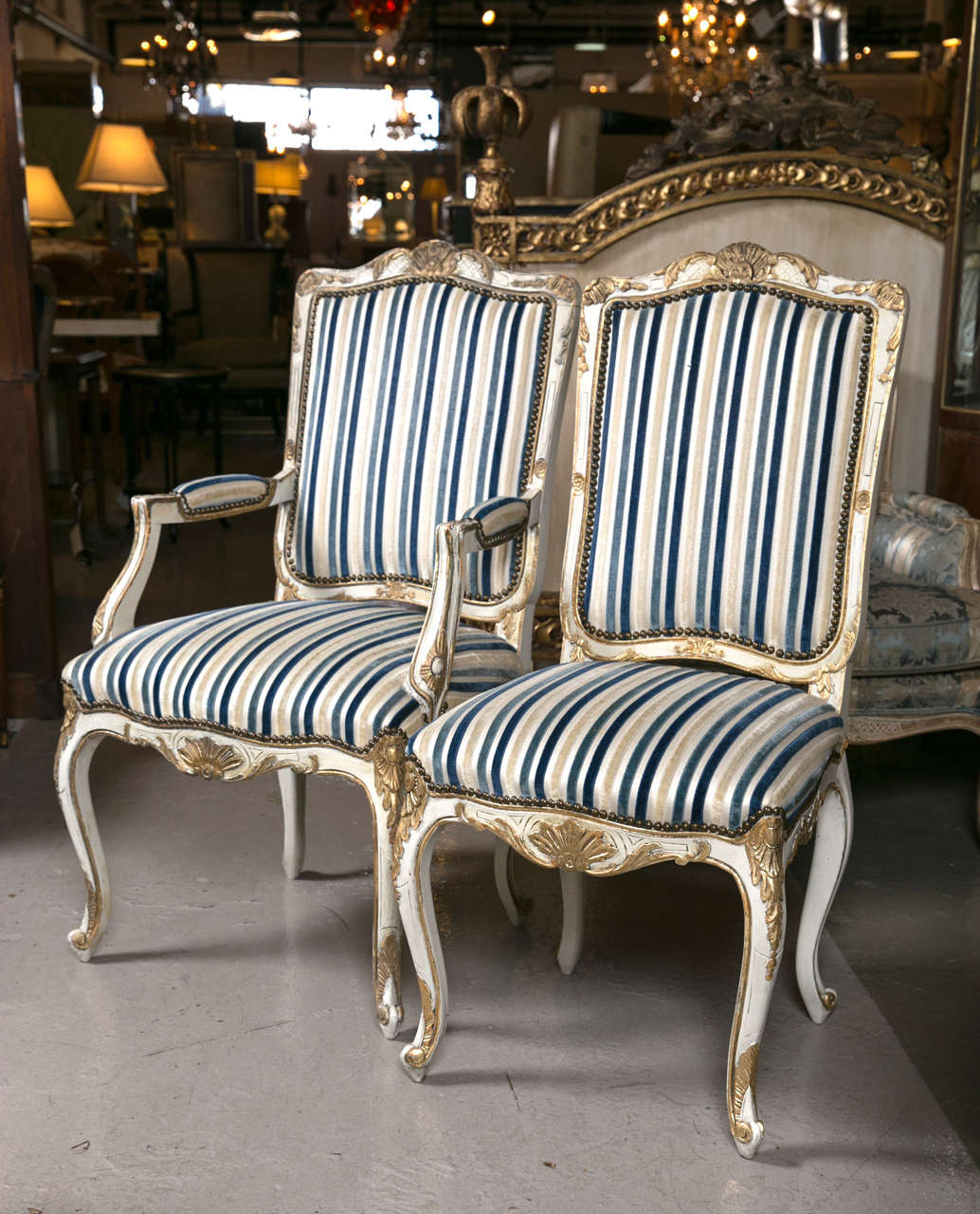 Set of eight Jansen style gilt gold and painted Louis XV dining chairs. This fine set of dining chairs came to us on approval from a Greenwich CT home. The highly detailed carving done is a gilt gold decorative work. The overall chair nicely painted