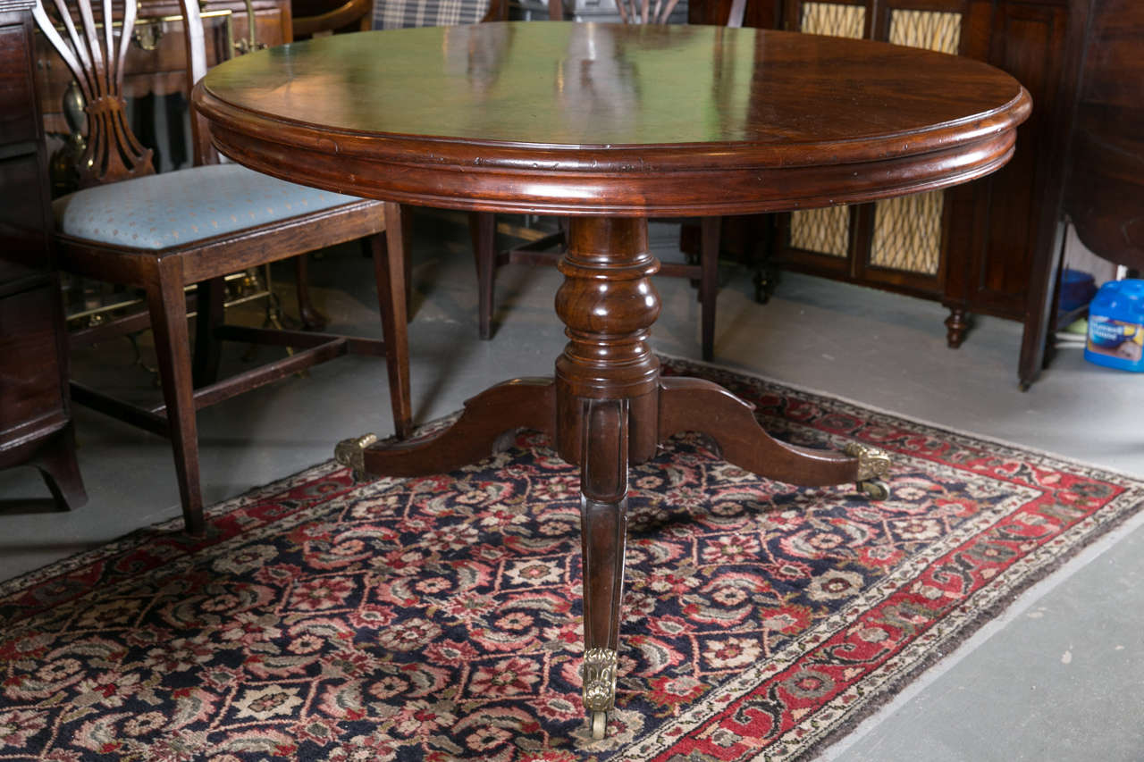 English regency round mahogany table, bookmark top, pedestal base. 1810.