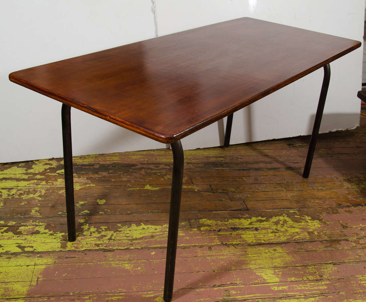 Wooden French schoolhouse table with metal, tubular legs, hand rubbed finish.