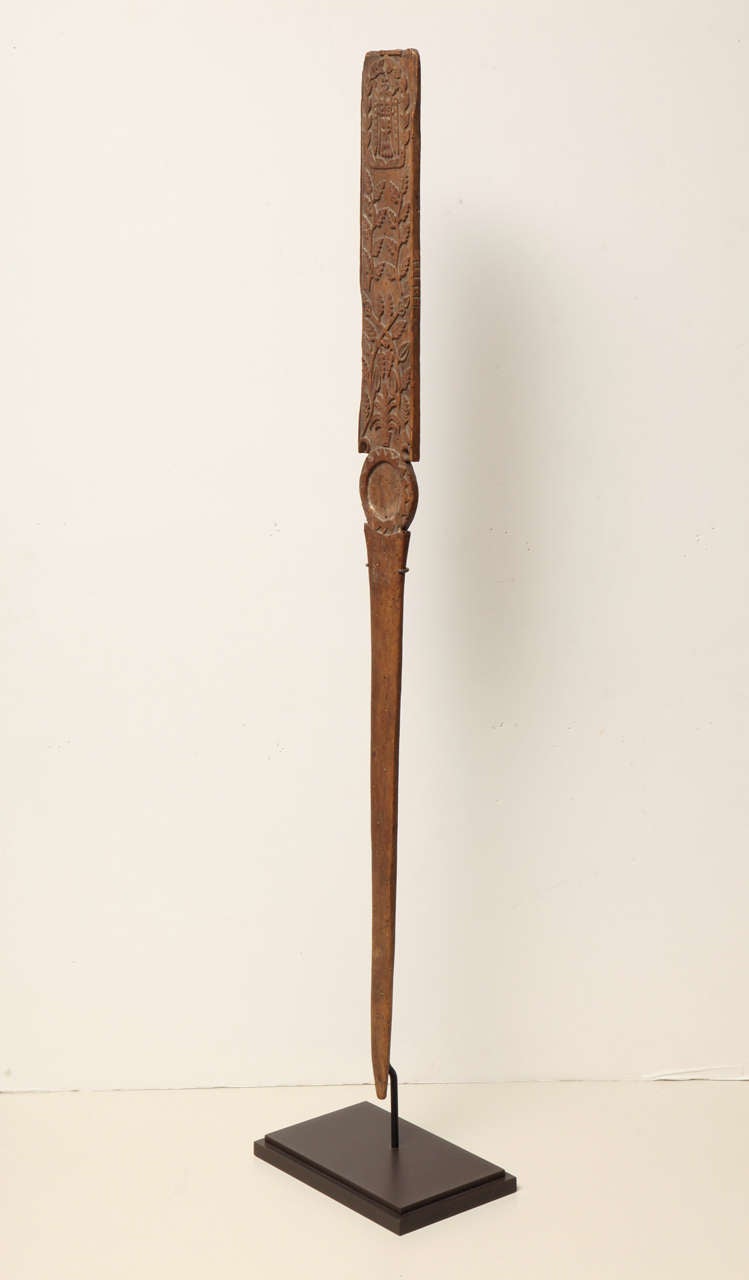 This Scandinavian implement was made around 1800, possibly in Sweden, for folding linen.  It is carved from wood, and is now dramatically  mounted on a modern bronze stand.